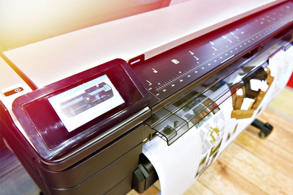 A printer placed on a table, occupying a significant space.